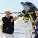 Michigan alumni Bob and Susan Guise, of Redington Shores, Fla., pose for a photograph next to a dolphin statue during beach day in Clearwater, Fla. on Sunday, Dec. 30. Melanie Maxwell I AnnArbor.com